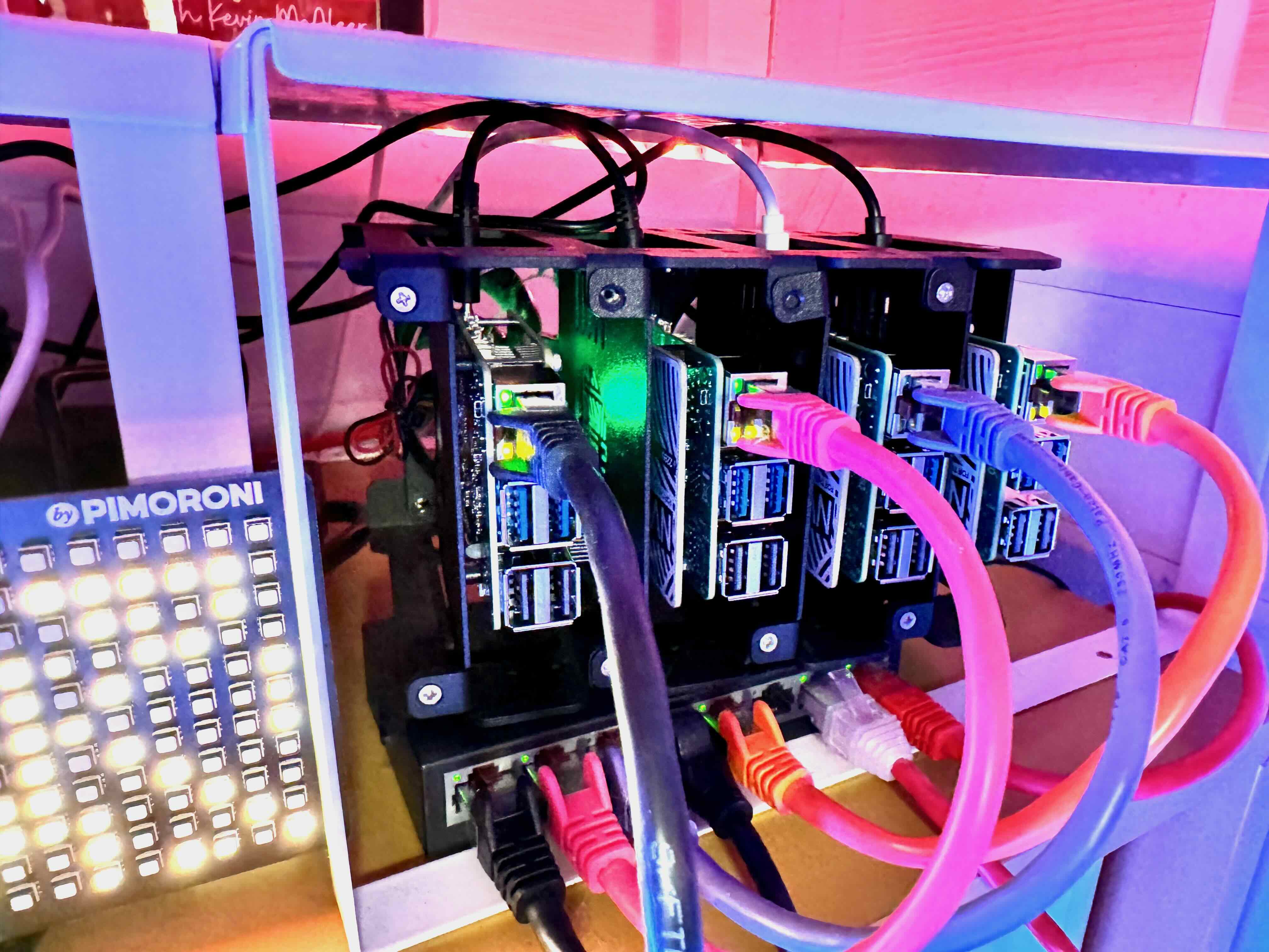 A cluster of 4 Raspberry Pi 5s with cables connected to a switch